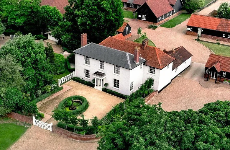 Aerial view of the Manor House at Vaulty Manor with the formal walled garden, gated front entrance and courtyard buildings.